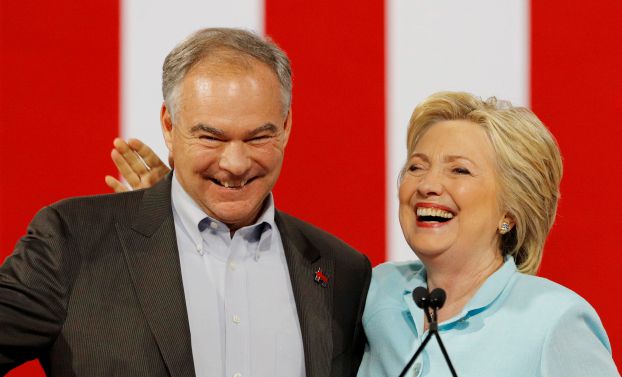Democratic U.S. vice presidential candidate Senator Tim Kaine (L) gets a pat on the back from his presidential running-mate Hillary Clinton after she introduced him during a campaign rally in Miami, Florida, U.S. July 23, 2016.  REUTERS/Scott Audette