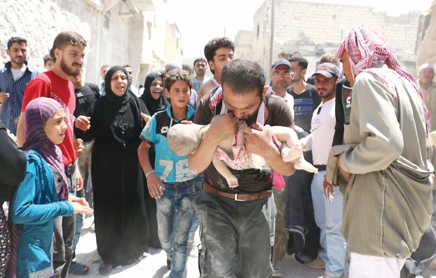A Syrian man holds the body of his child after it was taken from under the rubble of destroyed buildings following a reported air strike on the rebel-held neighbourhood of al-Marjah in the northern city of Aleppo, on July 24, 2016. Air raids have hit four makeshift hospitals in Syria's battered Aleppo city, doctors said, jeopardising medical care for more than 200,000 desperate civilians in rebel-held areas. The bombardment since July 23 has worsened the plight of residents of besieged eastern neighbourhoods of Syria's second city, where food and medical supplies are becoming increasingly scarce. / AFP PHOTO / AMEER ALHALBI